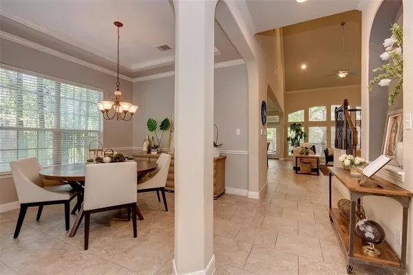 a living room with furniture a lamp and a chandelier