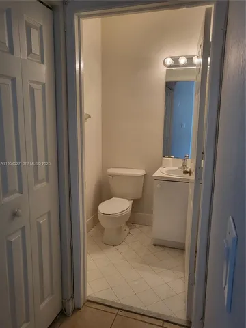 a white toilet sitting next to a bathroom sink