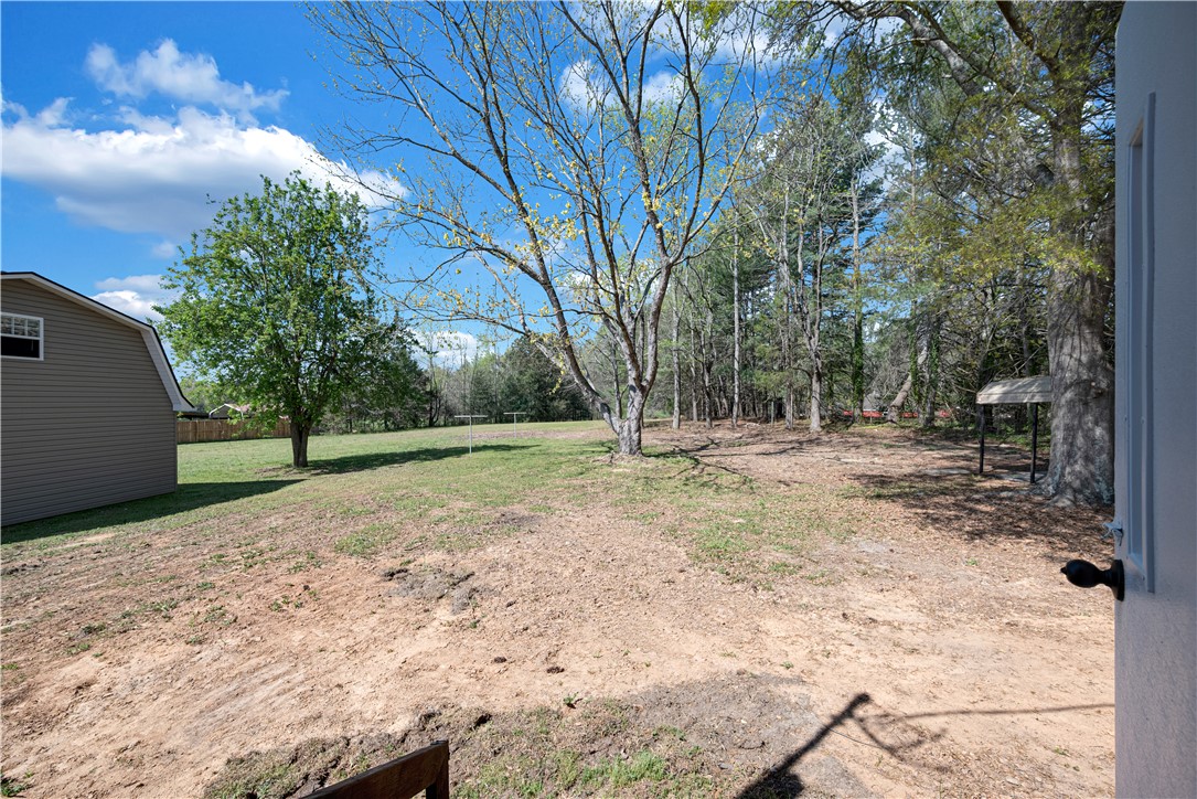 220 Bill Kay Road Belton, SC 29627 - Photo 15 of 30 This spacious yard offers a perfect blend of open green space and natural tree cover.