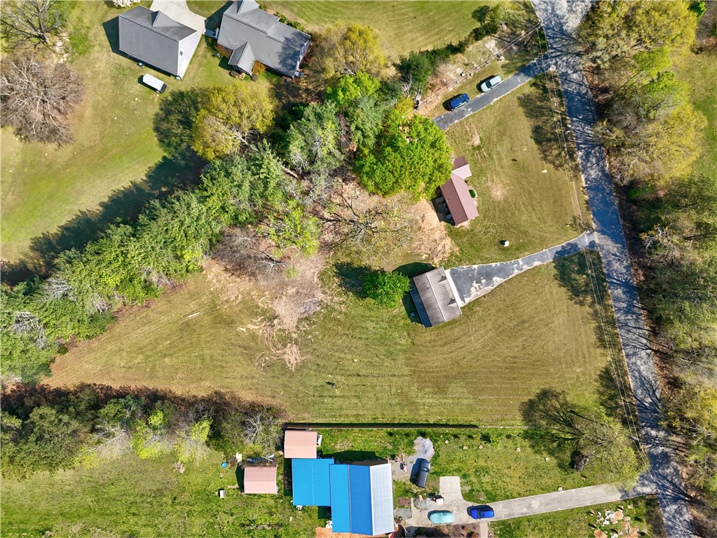 220 Bill Kay Road Belton, SC 29627 - Photo 22 of 30 An aerial view showcases vast green lawns and mature trees, highlighting expansive outdoor living.