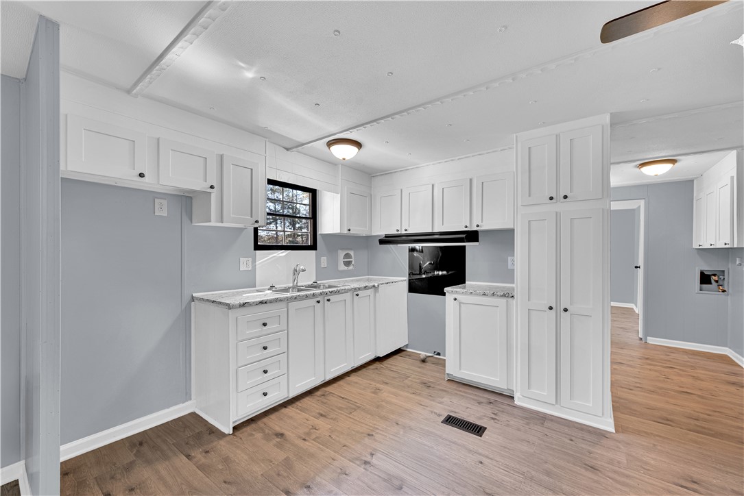 220 Bill Kay Road Belton, SC 29627 - Photo 6 of 30 This bright kitchen features ample cabinetry, generous counter space, and durable flooring for modern living.