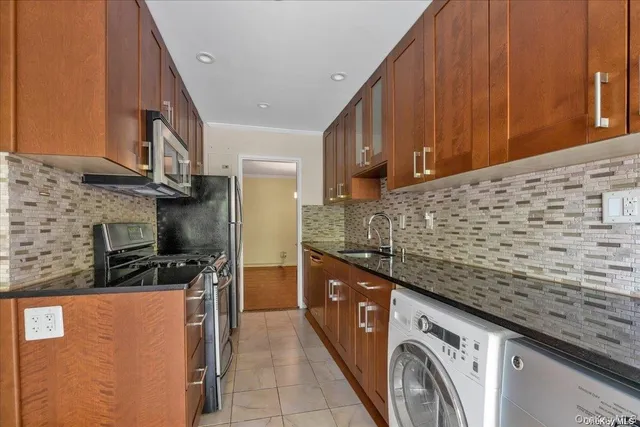 a kitchen with stainless steel appliances cabinets a sink and a stove