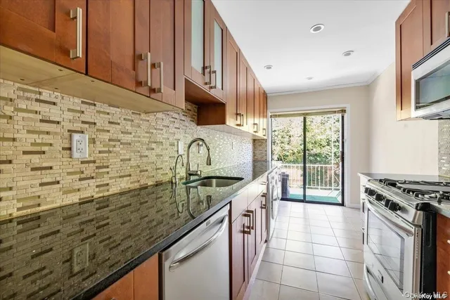 a bathroom with a granite countertop sink and washing machine