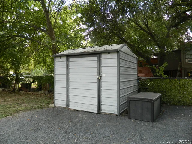 a kitchen with granite countertop cabinets and wooden floor