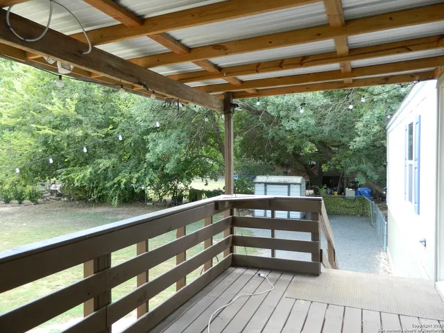 a view of a chairs and table in patio with wooden floor