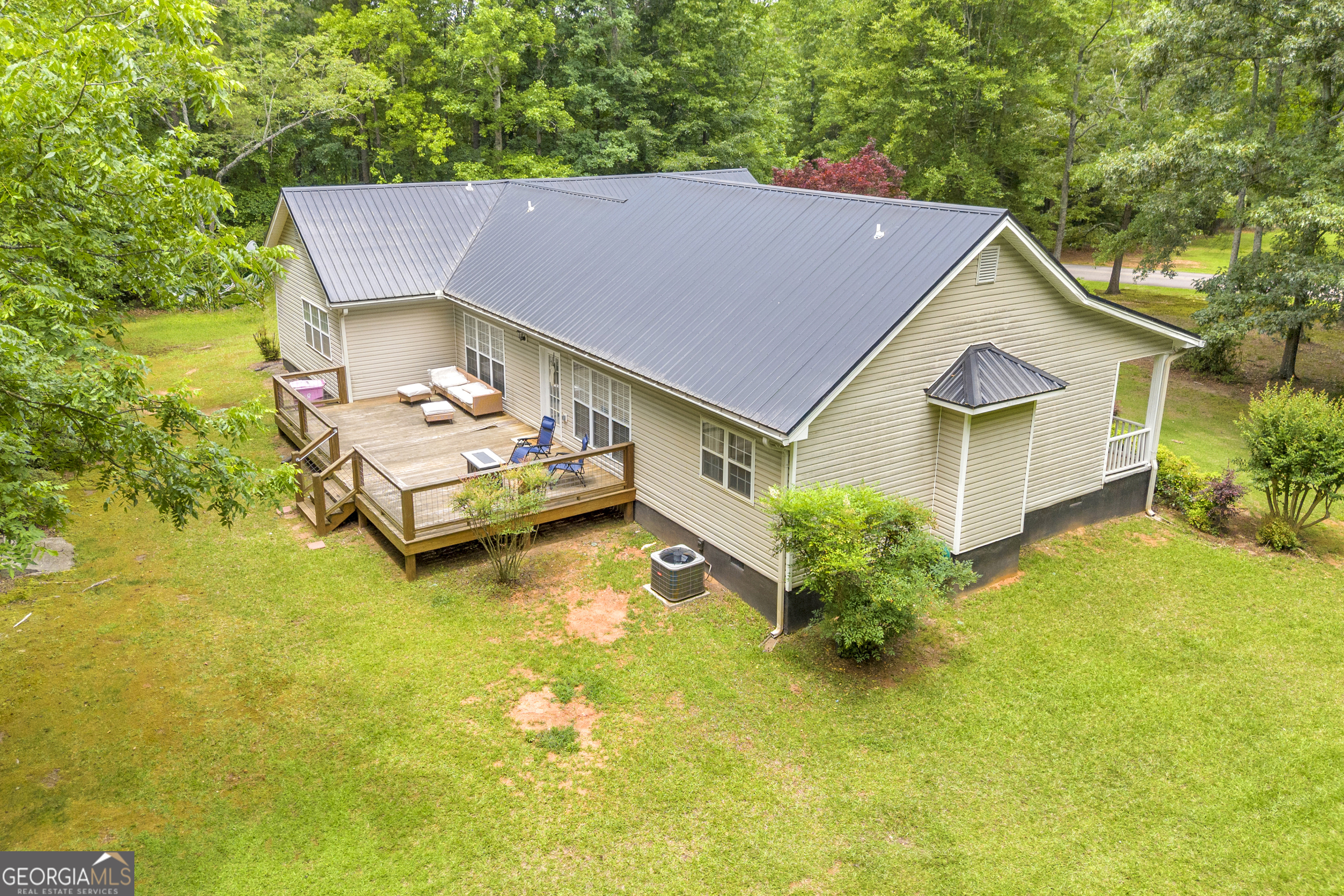 163 Tuxedo Drive Commerce, GA 30530 - Photo 51 of 62 a house with garden in front of it