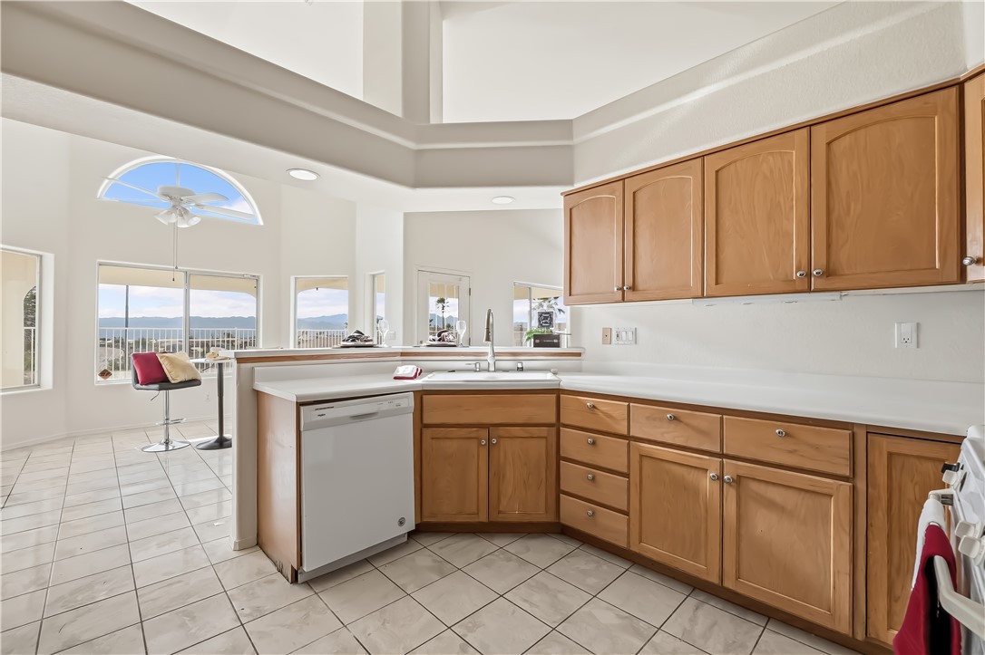 2853 Winchester Road Bullhead City, AZ 86442 - Photo 21 of 40 Kitchen featuring light wood cabinetry, white countertops, and a white tile floor