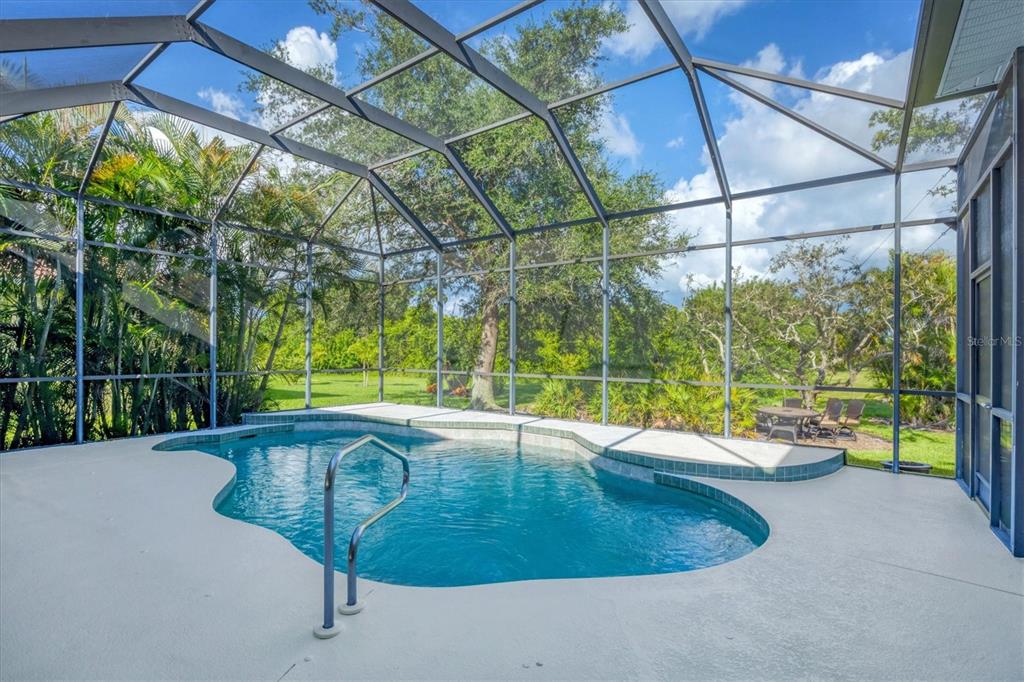 4 Windward Way Placida, FL 33946 - Photo 21 of 39 a view of a swimming pool with a patio and a yard