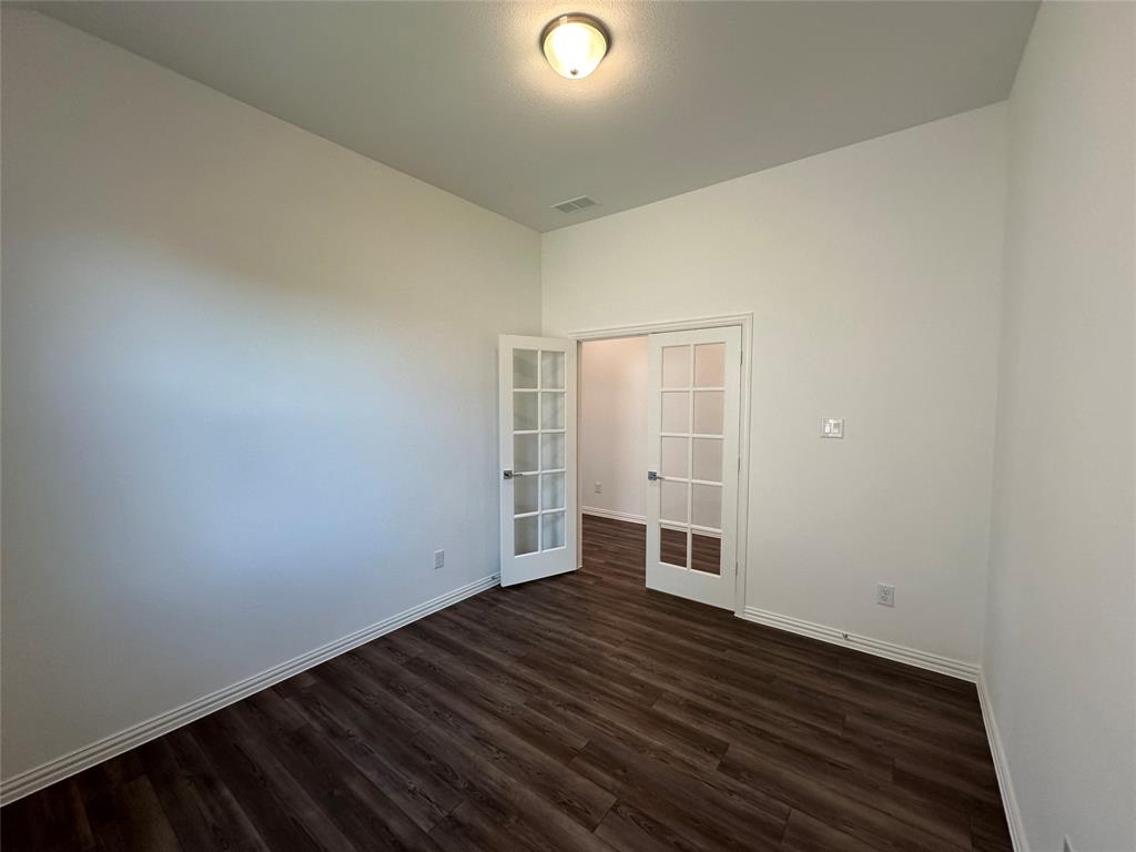 3401 Paintbrush Path Melissa, TX 75454 - Photo 16 of 39 Unfurnished room with french doors and dark wood-style floors