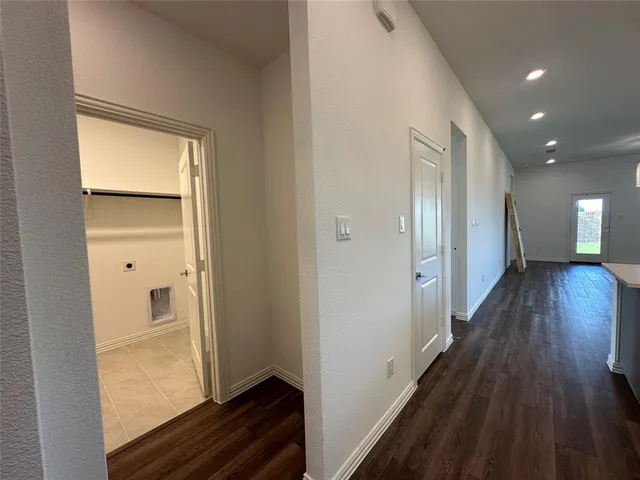 a view of hallway with wooden floor