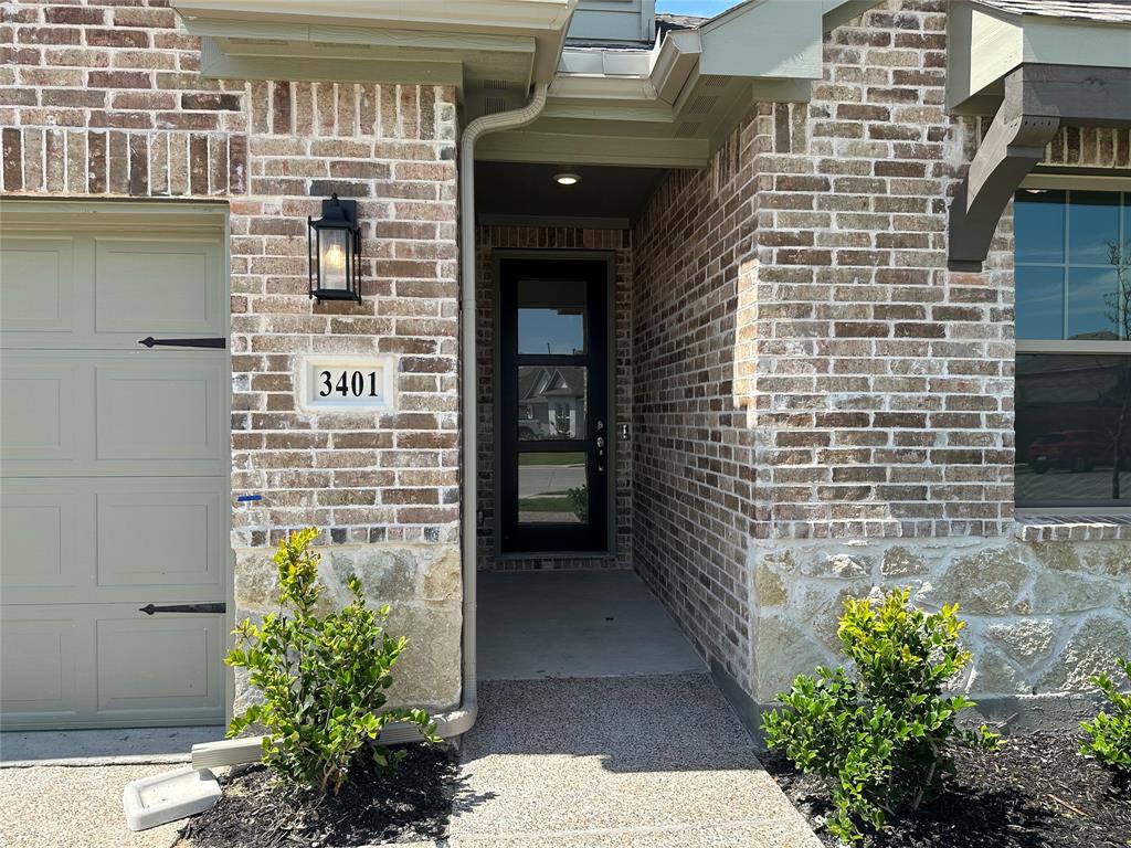 3401 Paintbrush Path Melissa, TX 75454 - Photo 2 of 39 Doorway to property with a garage and brick siding