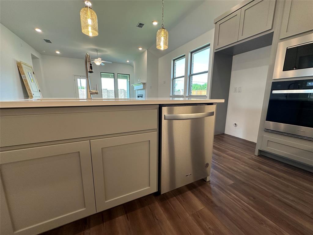 3401 Paintbrush Path Melissa, TX 75454 - Photo 38 of 39 Kitchen featuring stainless steel appliances, a ceiling fan, decorative light fixtures, dark wood-style floors, and open floor plan