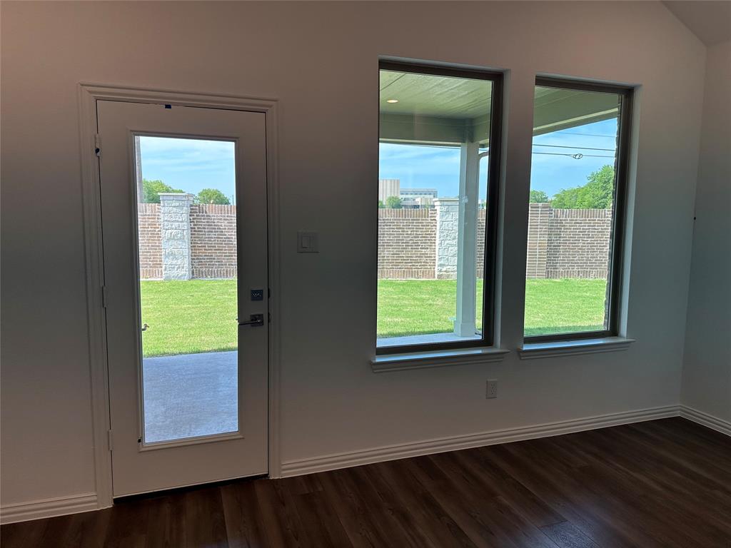 3401 Paintbrush Path Melissa, TX 75454 - Photo 30 of 39 Doorway to outside featuring plenty of natural light and wood finished floors