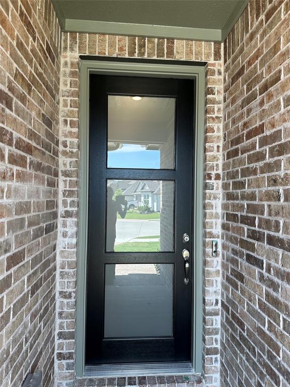 3401 Paintbrush Path Melissa, TX 75454 - Photo 4 of 39 Doorway to property with brick siding