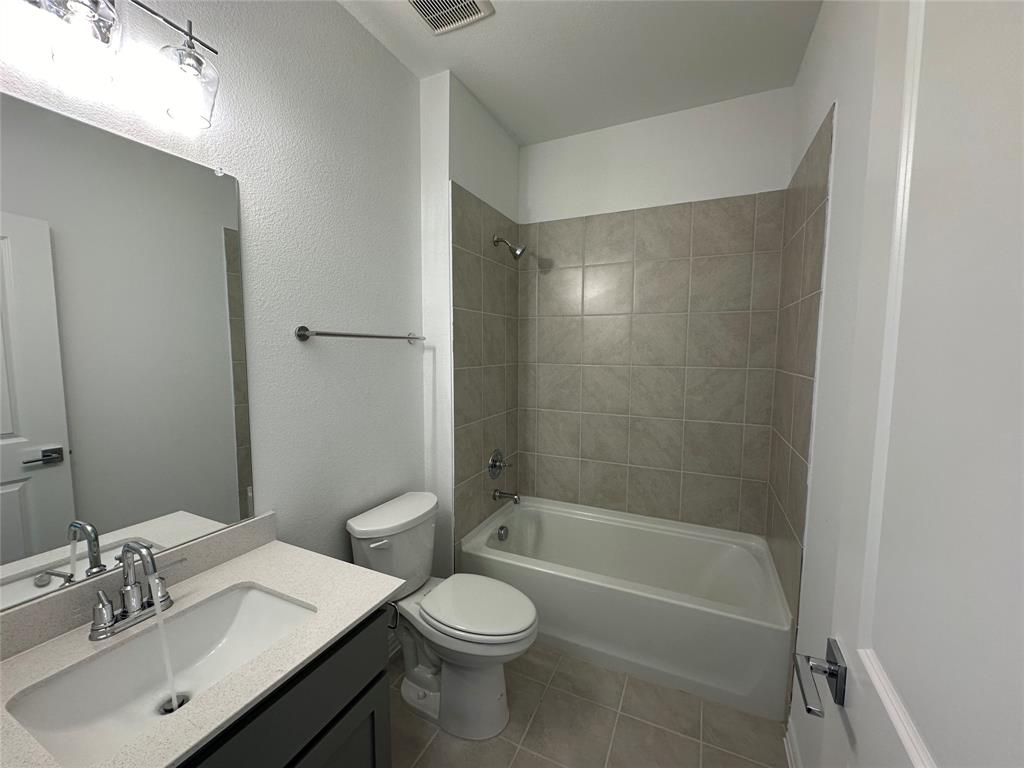 3401 Paintbrush Path Melissa, TX 75454 - Photo 8 of 39 Full bath with shower / tub combination, vanity, light tile patterned floors, and a textured wall