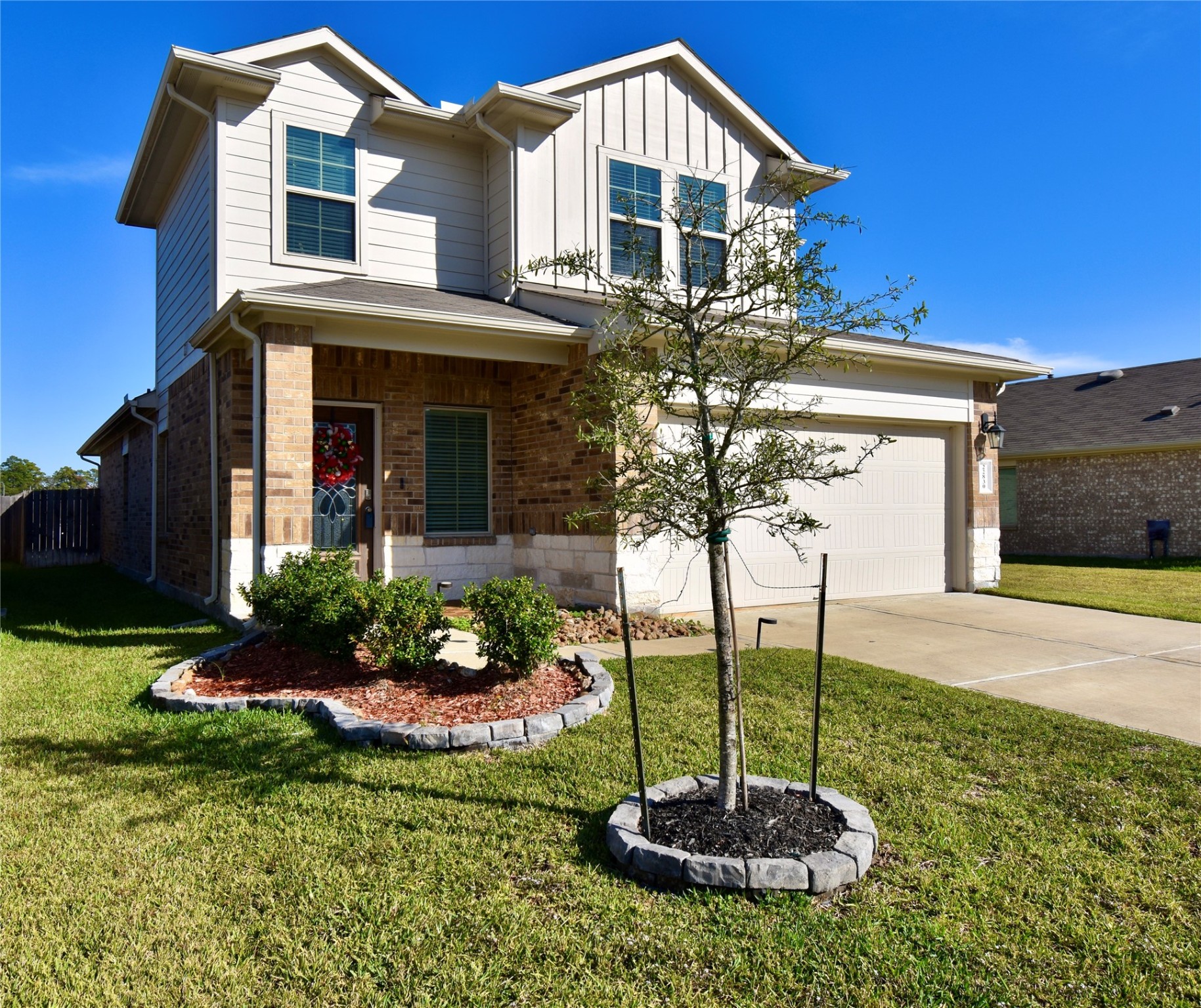 22830 Zephyr Vly Trail Spring, TX 77373 - Photo 4 of 17 a front view of a house with a yard and potted plants