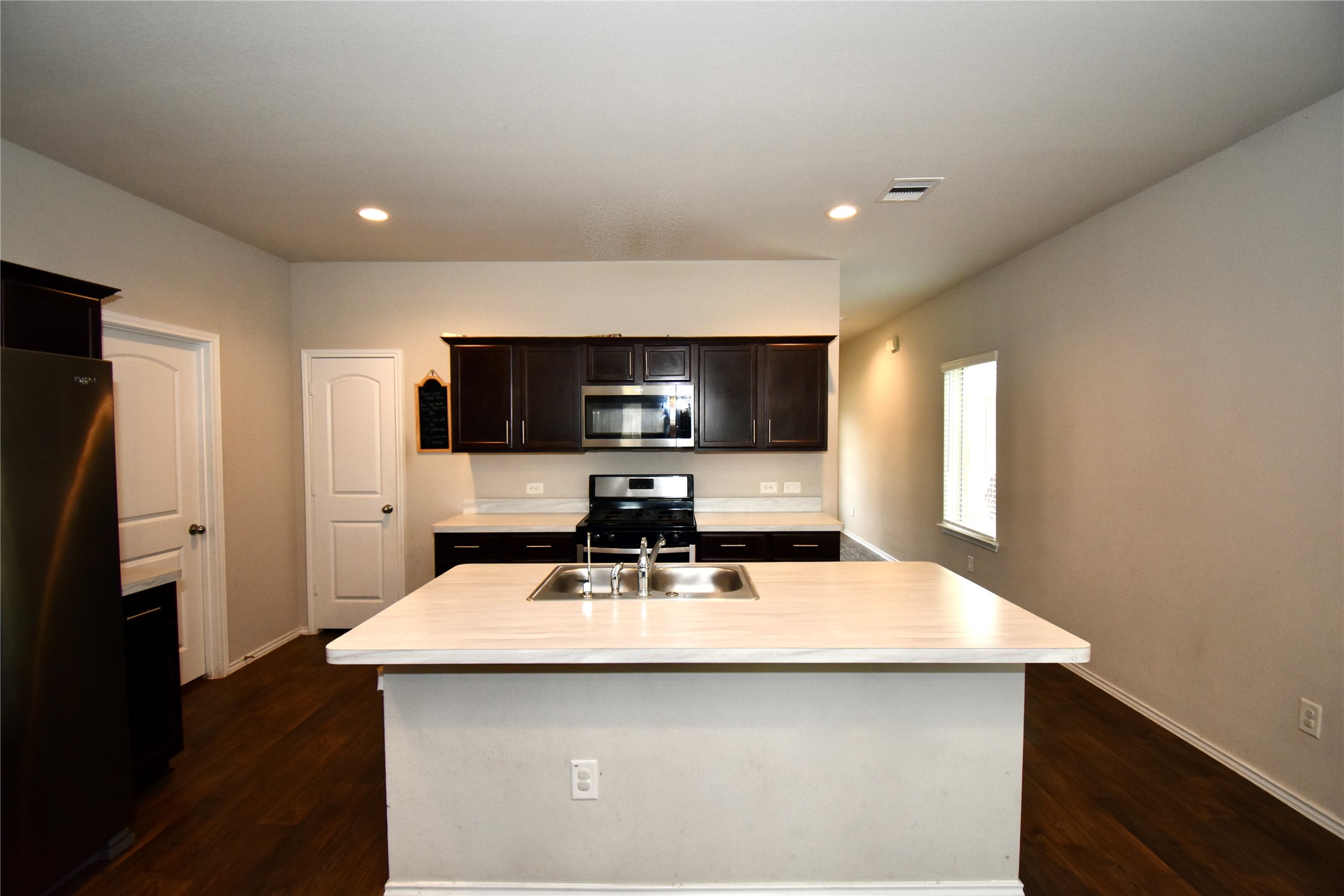 22830 Zephyr Vly Trail Spring, TX 77373 - Photo 7 of 17 a kitchen with a sink a counter top space and stainless steel appliances