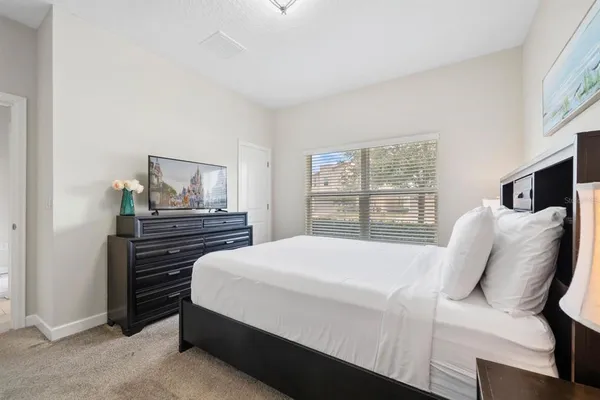 a bedroom with a bed and dresser