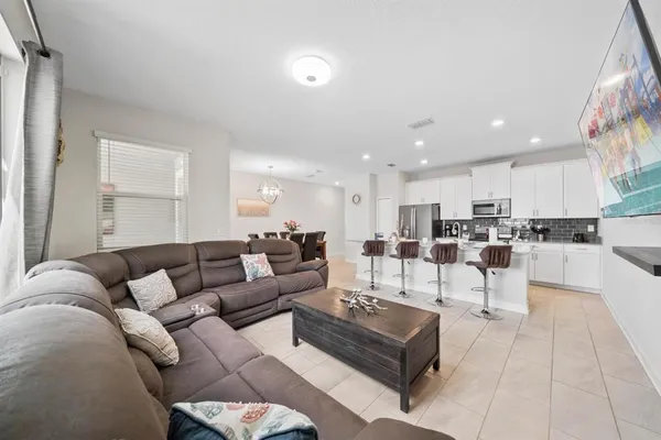 a living room with furniture and kitchen view