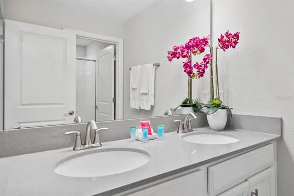 a bathroom with a glass shower door