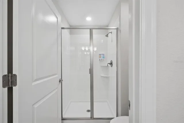 a bedroom with two beds and a flat screen tv