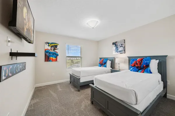a bedroom with a bed and painting on the wall
