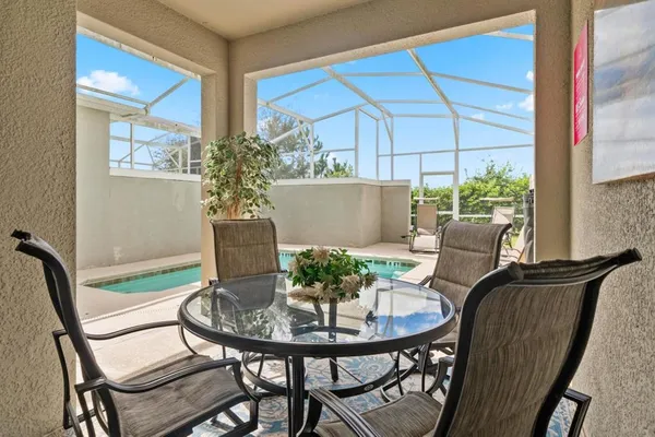 a view of a chairs and table in a backyard