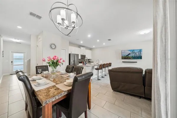 a dining room with furniture and a chandelier