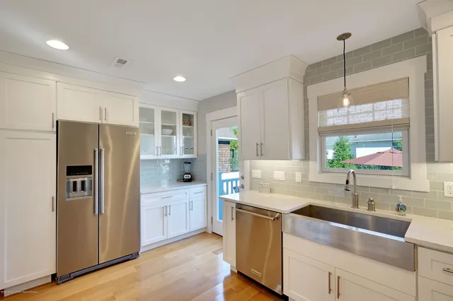 a kitchen with refrigerator and cabinets