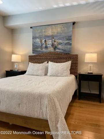 a bedroom with a bed and a night stand