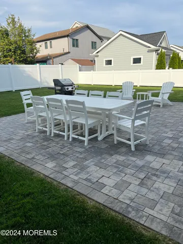 a view of a house with backyard and a patio