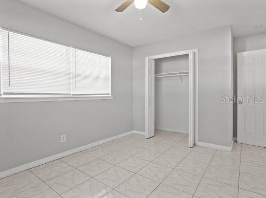 5614 Riviera Drive Orlando, FL 32808 - Photo 15 of 17 an empty room with windows and fan