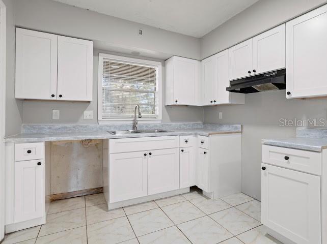 5614 Riviera Drive Orlando, FL 32808 - Photo 3 of 17 a kitchen with granite countertop white cabinets white stainless steel appliances and sink