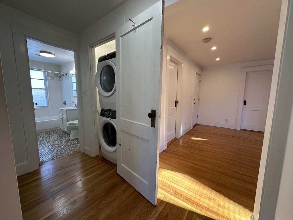 76 Wenham Street, Unit 3 Boston, MA 02130 - Photo 13 of 23 a bedroom with wooden floor and glass door