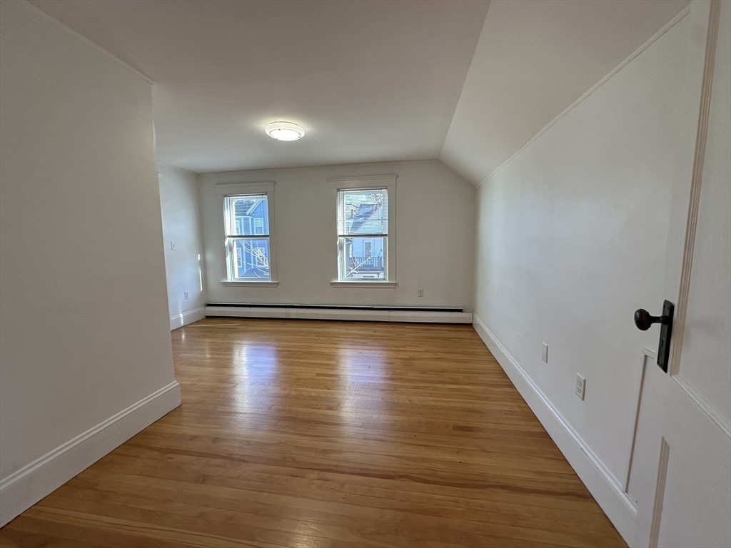 76 Wenham Street, Unit 3 Boston, MA 02130 - Photo 18 of 23 wooden floor in an empty room with a window
