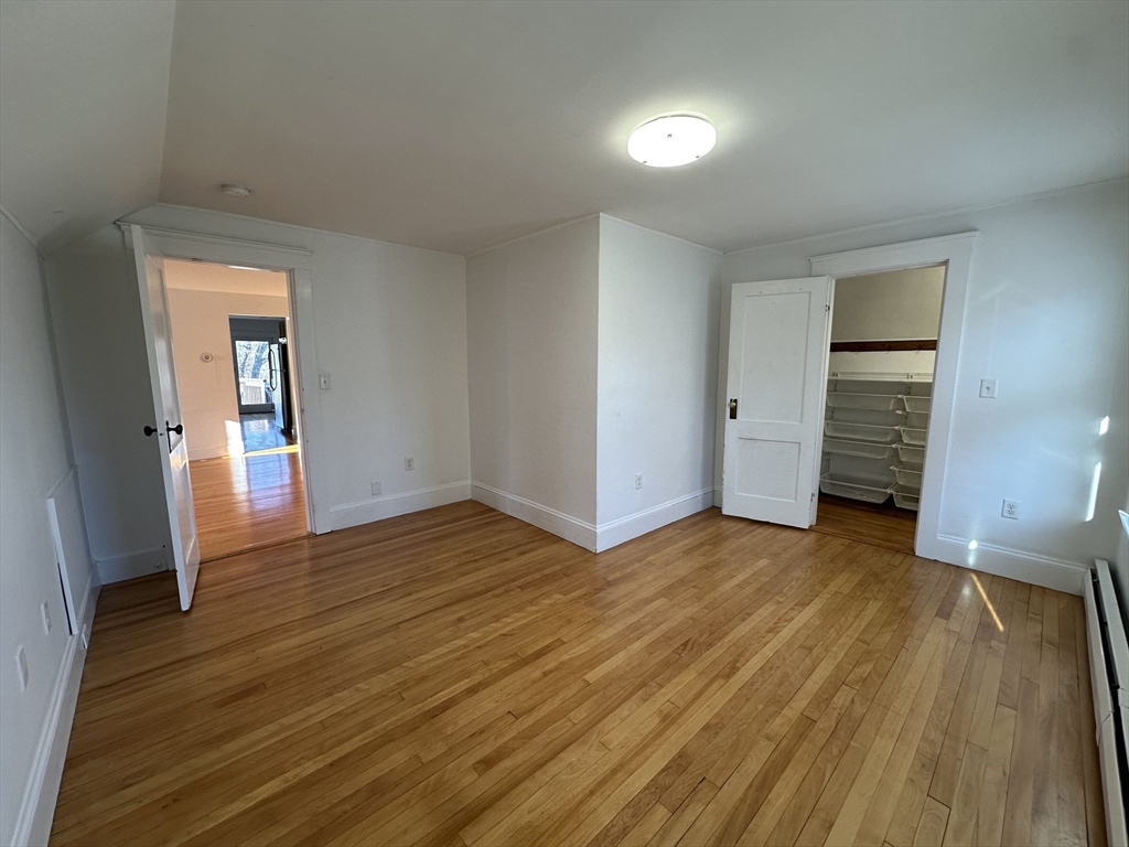 76 Wenham Street, Unit 3 Boston, MA 02130 - Photo 20 of 23 an empty room with wooden floor and closet
