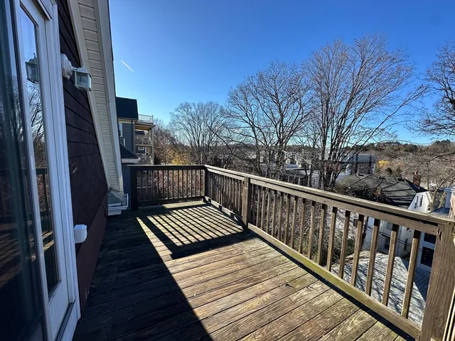 a view of balcony with wooden floor and fence