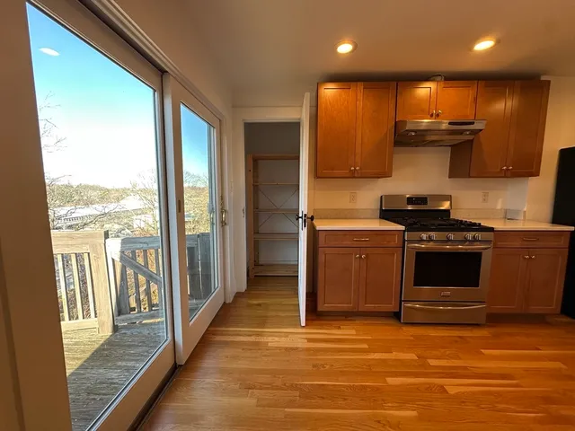 a kitchen with stainless steel appliances granite countertop a stove a sink and a refrigerator