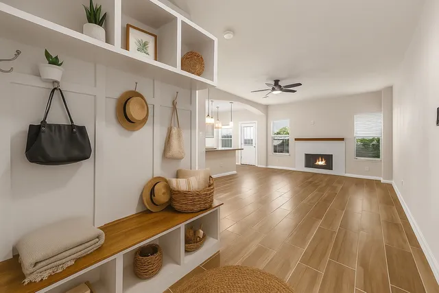 a hallway with a chair a fireplace and a workspace