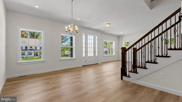 an empty room with kitchen and fireplace