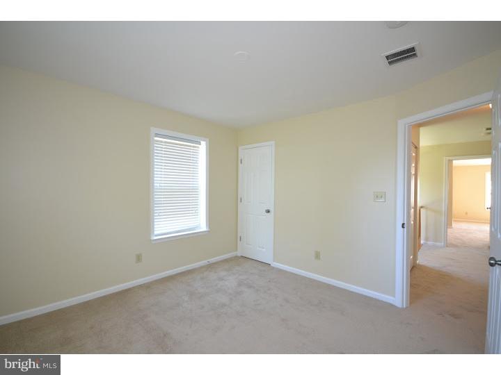 487 Buchanan Road Perkasie, PA 18944 - Photo 21 of 25 a view of an empty room with wooden floor and a window