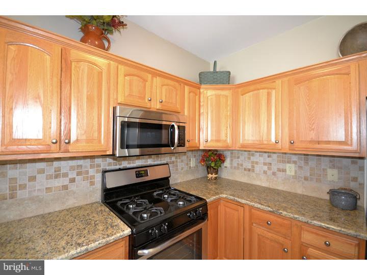 487 Buchanan Road Perkasie, PA 18944 - Photo 5 of 25 a kitchen with granite countertop a stove a sink dishwasher and a microwave
