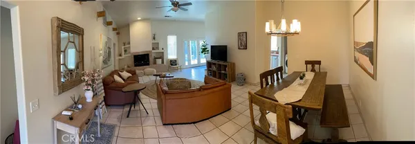a living room with furniture a mirror and a chandelier
