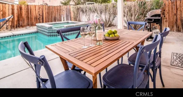 a view of a dining table and chairs in the patio