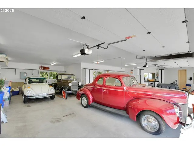 a view of a garage with cars and a garage