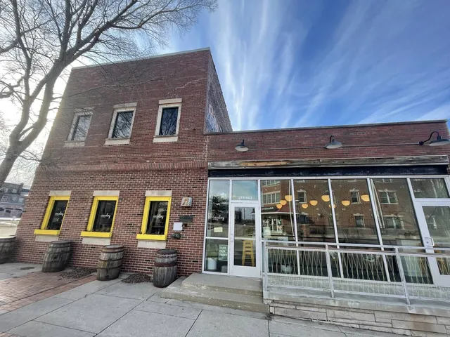 a view of a brick house with large windows