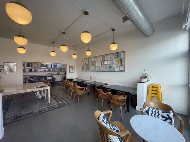 a living room with lots of furniture and painting on the wall