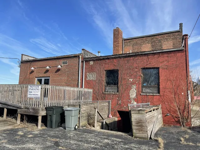 a car parked in front of house with a parking area