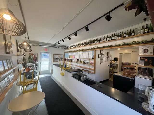 a kitchen with a table chairs stove and cabinets