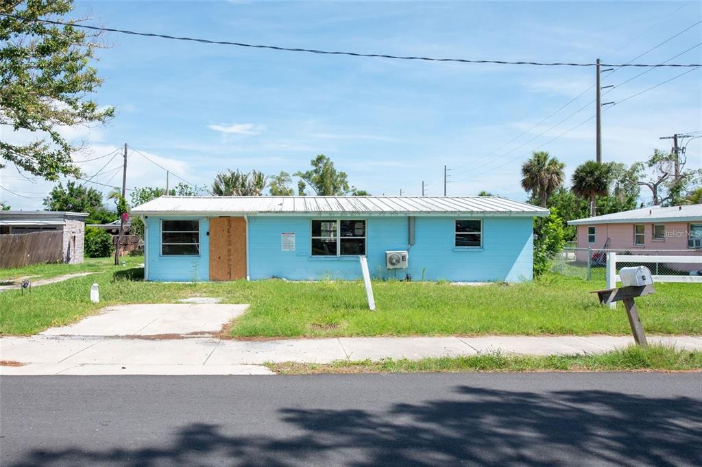 1695 Manor Road Englewood, FL 34223 - Photo 11 of 37 a front view of a house with a yard and a garage